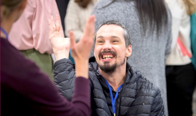 A white male high fiving another attendee